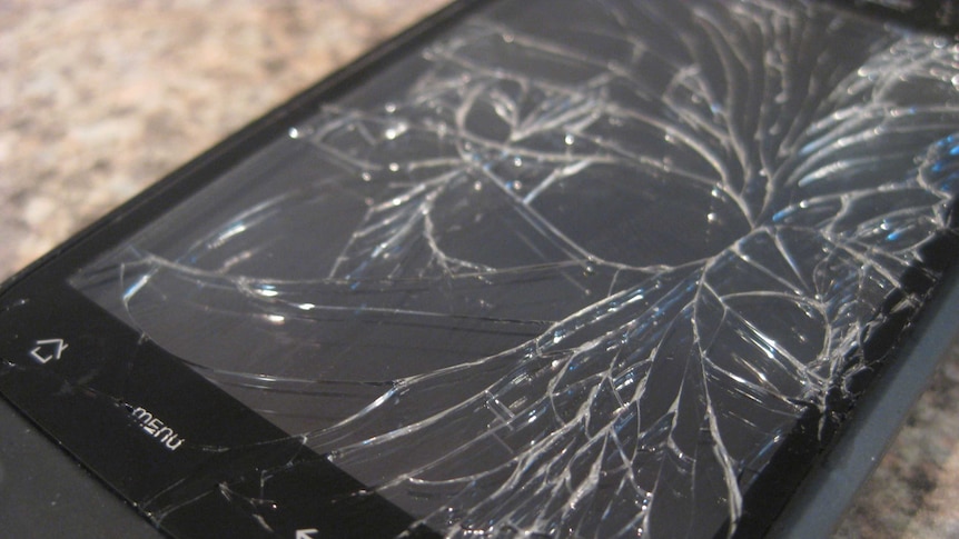 Close-up shot of a smartphone with a cracked screen.