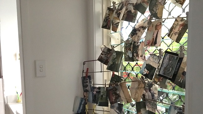 Photos are clipped to a window to dry after being damaged in Townsville flood.