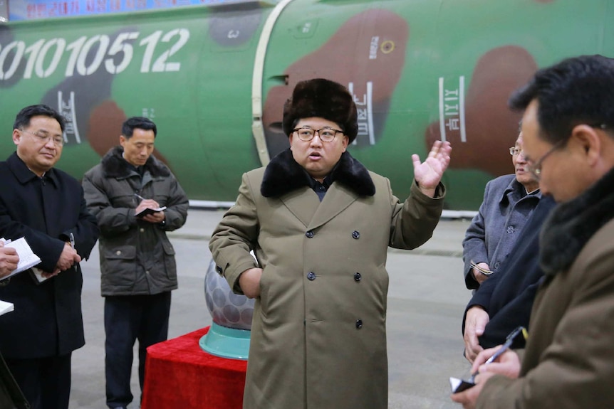 North Korean leader Kim Jong-un talking to nuclear scientists.