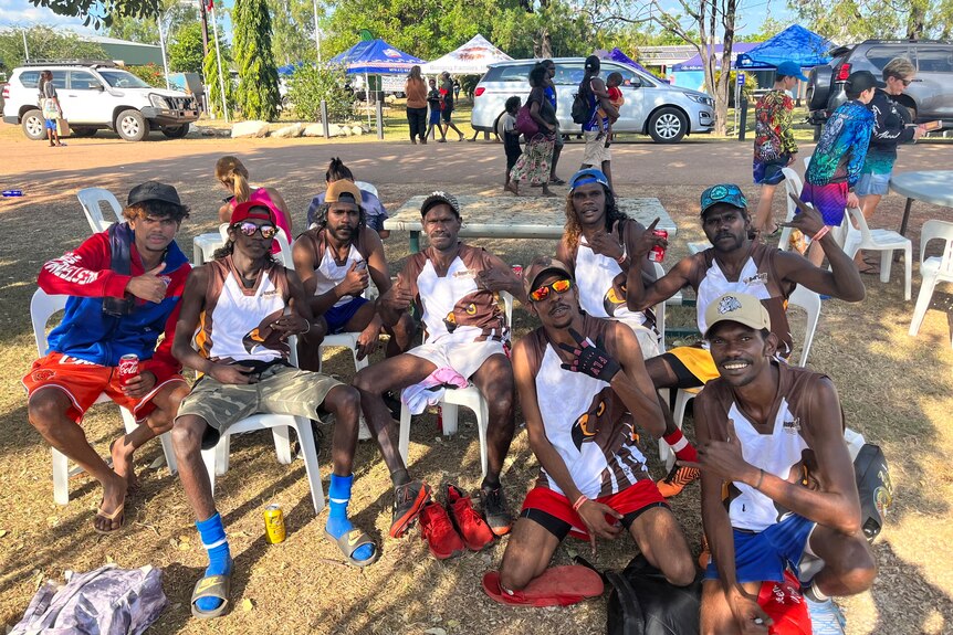 A football team sitting on chairs at the Barunga Festival in the Northern Territory.