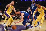 LA Clippers guard Austin Rivers (25) drives ball defended by Los Angeles Lakers centre Andrew Bogut.