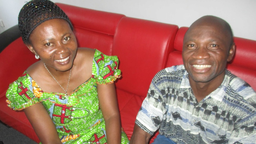 Washikala and Theophile Balebanga sit on a red couch.