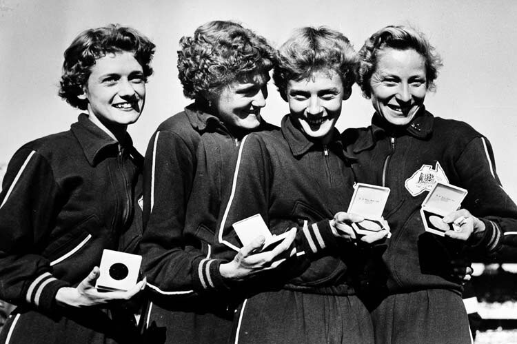 Black-and-white photo of victorious Australian women's 4 x 100 metres track relay team at the 1956 Olympics.