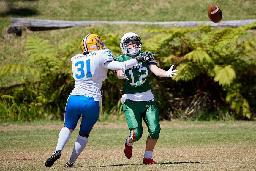 A UNSW Raiders player trying to catch the ball.