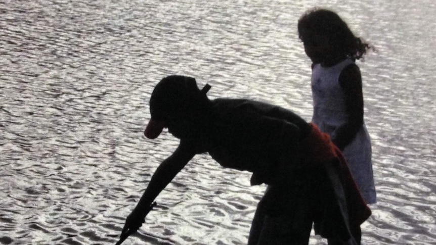 Children playing in water, a photo from the Tasmanian Aboriginal Centre report Keeping our Children With Us.