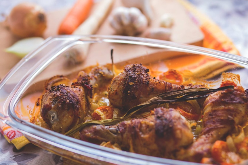 Chicken drumsticks in an oven tray.