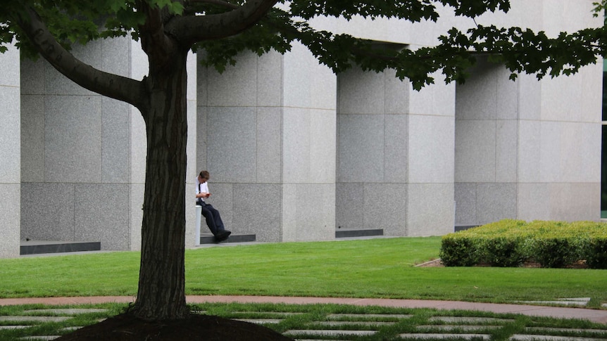 A worker enjoys the surroundings of the Senate courtyard.
