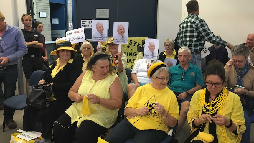 Protestors sitting at the first meeting of the new Mid Coast Council