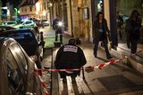 Police examine the site in Dijon where a driver ploughed into a crowd injuring 11 people.