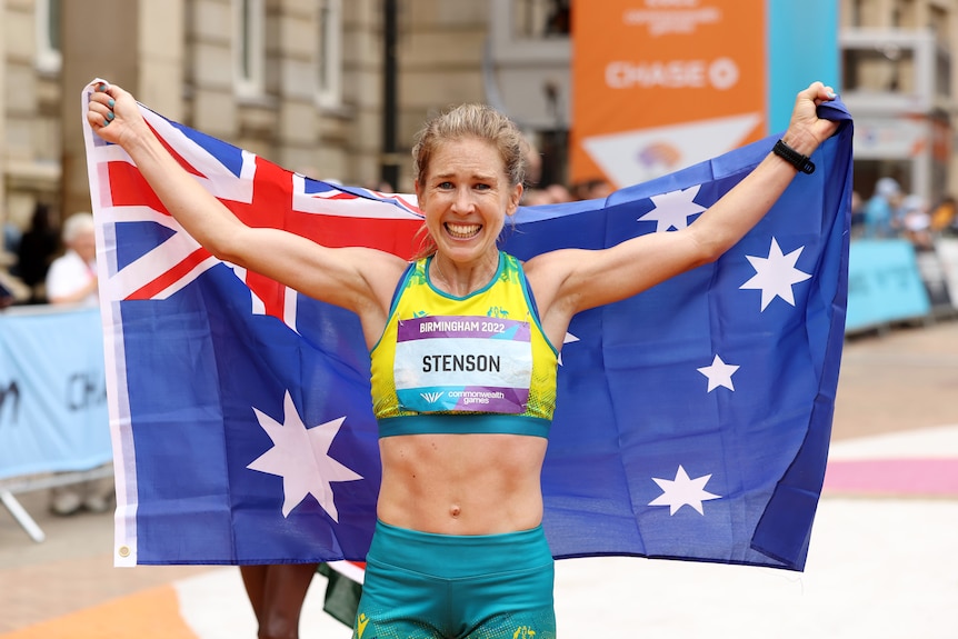Jess Stenson holds up an Australia flag
