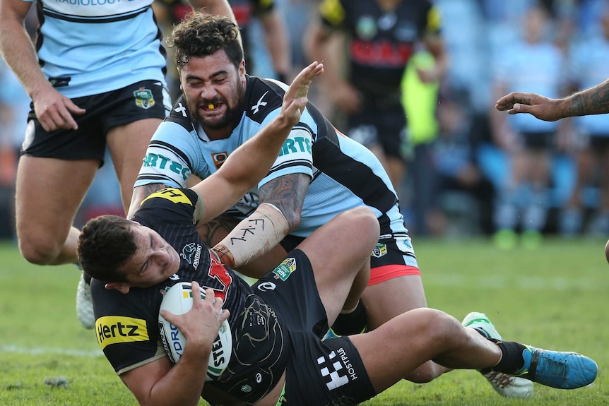 Andrew Fifita of the Sharks tackles Reagan Campbell-Gillard of the Panthers during the round 8 NRL match between the Cronulla-Sutherland Sharks and the Penrith Panthers at Shark Park in Sydney