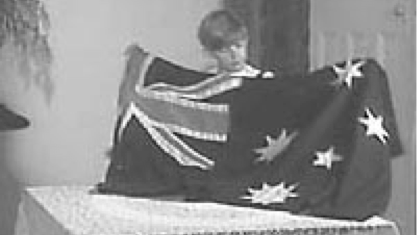 a little boy holds the australian flag