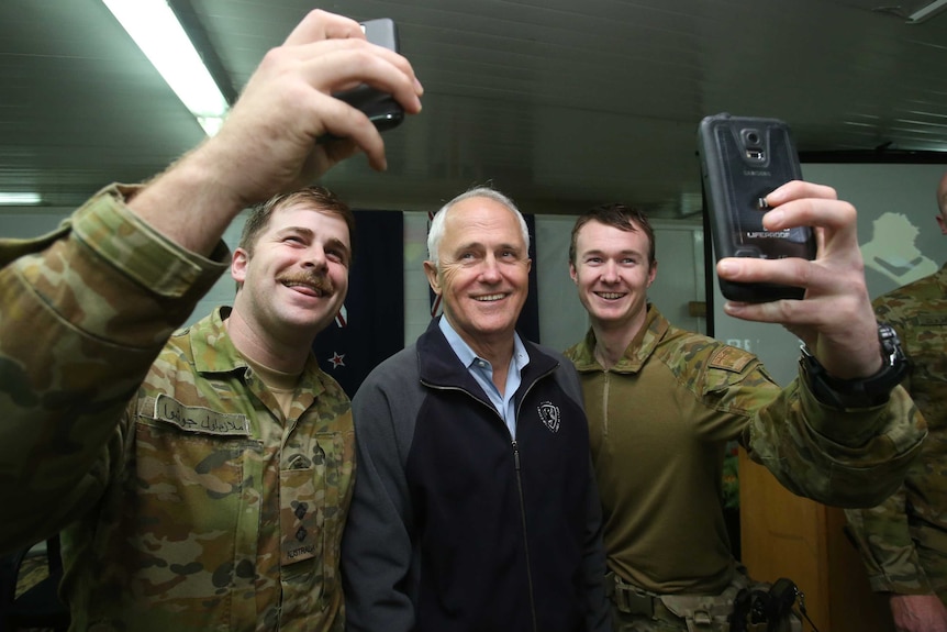 Prime Minister Malcolm Turnbull takes selfies with Australian troops in Iraq