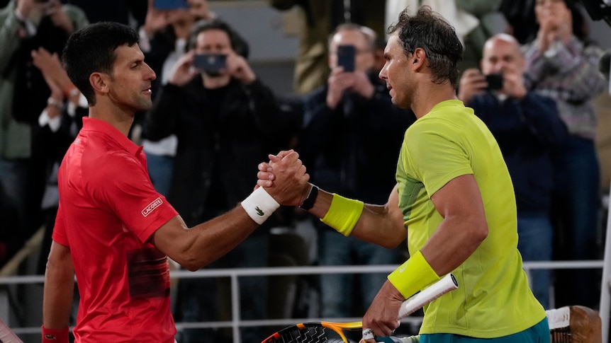 Novak Djokovic and Rafael Nadal shake hands at the net after a French Open quarter-final.