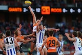 The Giants' Jonathan Giles leaps highest at the ruck contest against the Kangaroos.