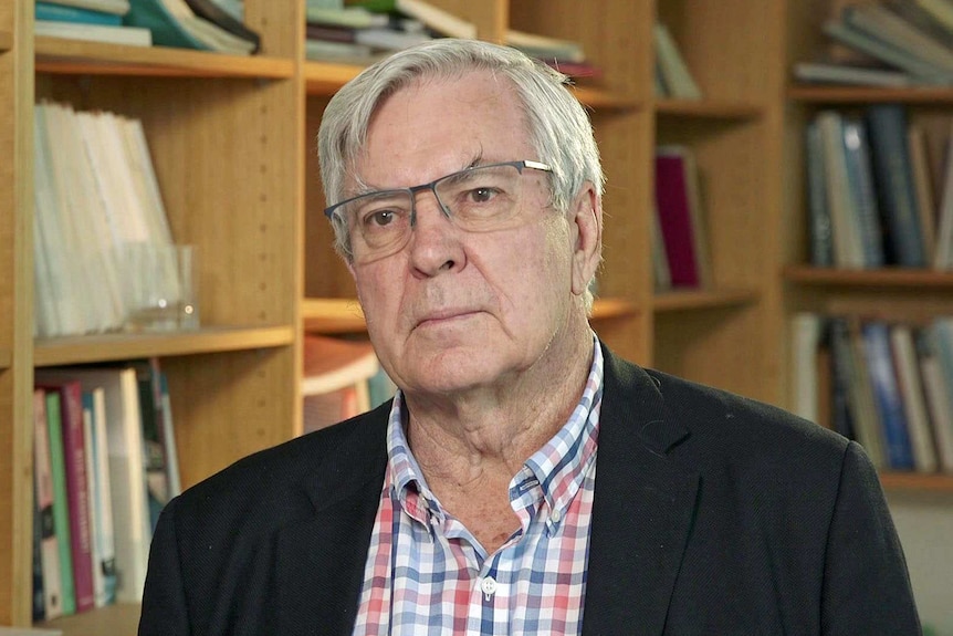 Bob Gregory wears a check shirt and suit jacket.