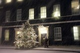 A policeman stands next to a Christmas tree outside 10 Downing Street