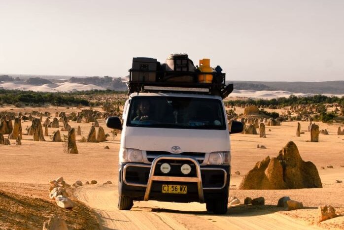 A van drives through Pinnacles Desert