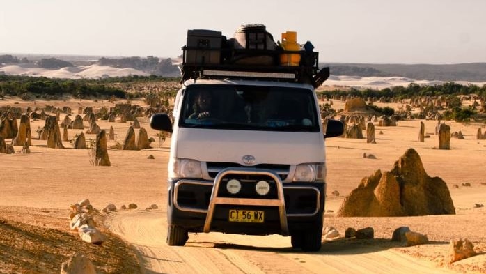 A van drives through Pinnacles Desert