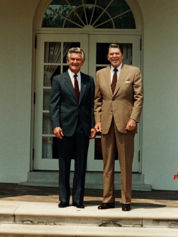 Bob Hawke stands next to US President Ronald Reagan smiling in front of the White House in 1983.