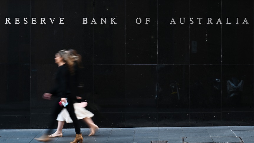 People walking past the outside of the Reserve Bank of Australia in Sydney.