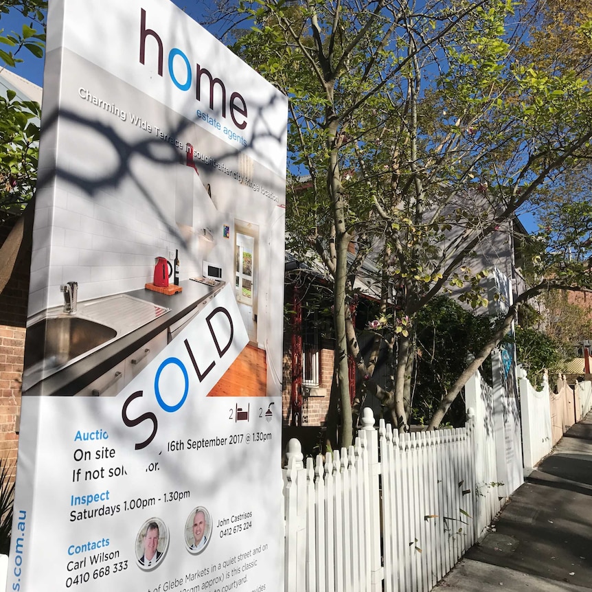 House sold sign outside a row of terraces in the inner-Sydney suburb of Glebe