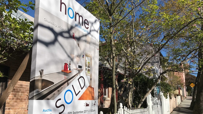 House sold sign outside a row of terraces in the inner-Sydney suburb of Glebe