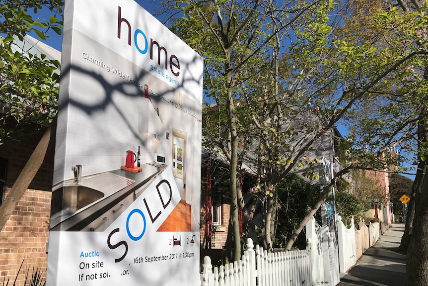 House sold sign outside a row of terraces in the inner-Sydney suburb of Glebe