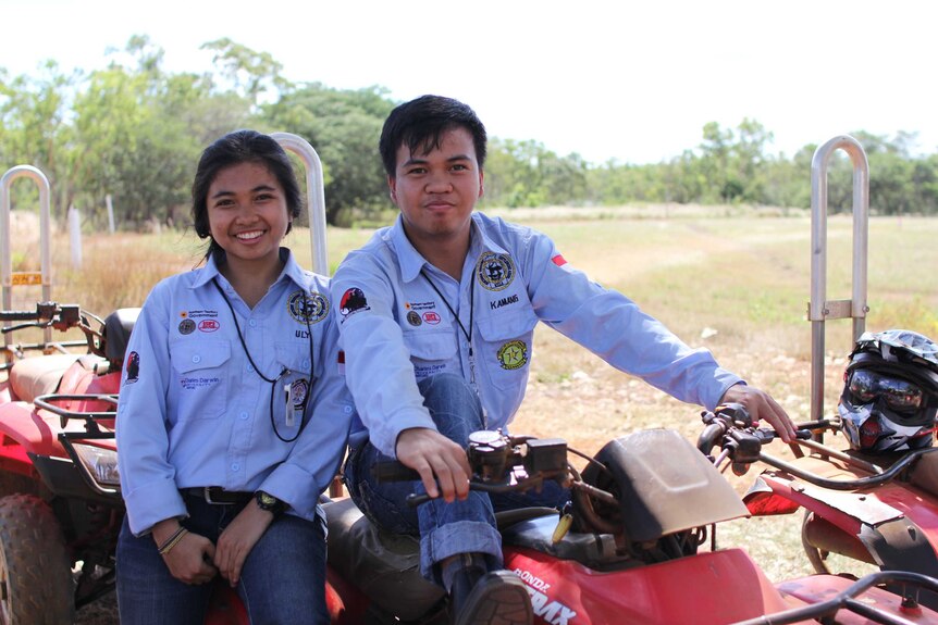 two people sit on a quad bike