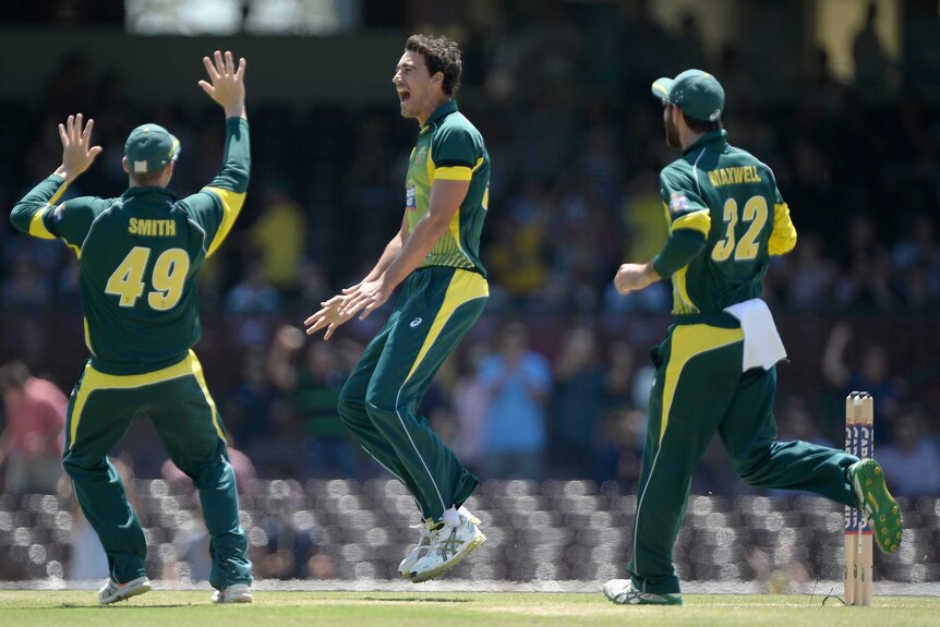 Mitchell Starc of Australia celebrates with teammates after dismissing James Taylor of England