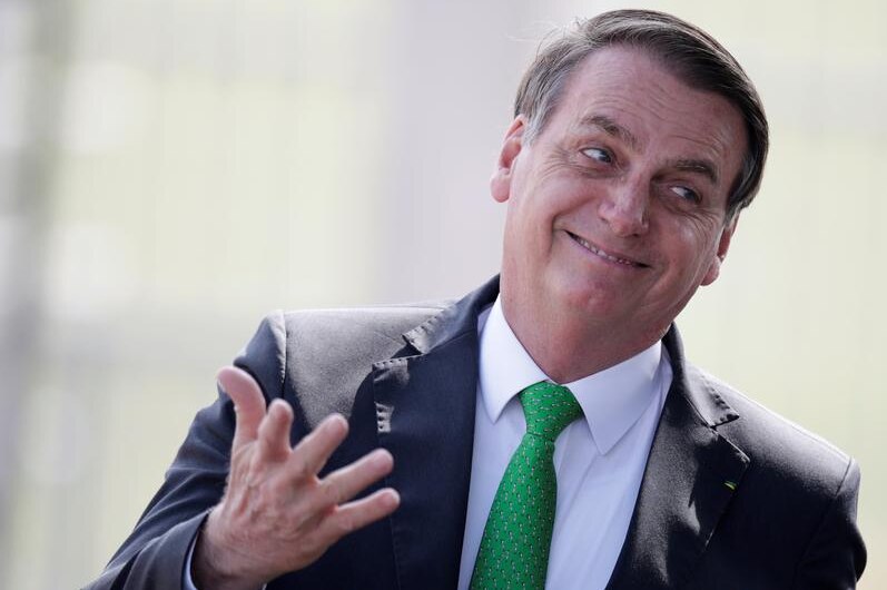 Brazil's President Jair Bolsonaro wearing a suit and green tie.