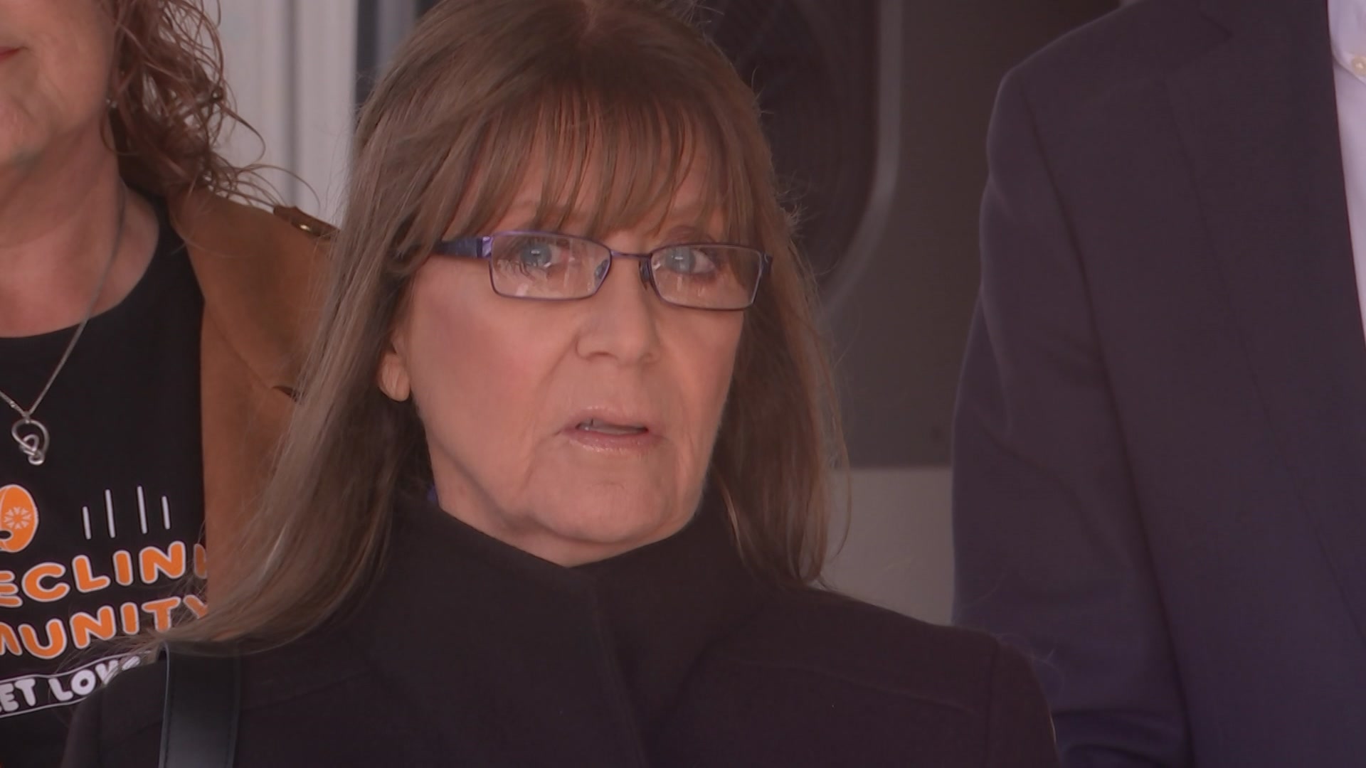 A woman with brown hair and glasses with a concerned expression on her face