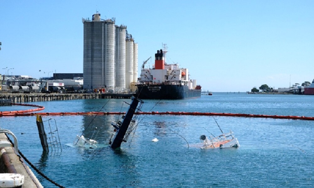 Tugboats York Cove and Campbell Cove submerged with Goliath ship in background.