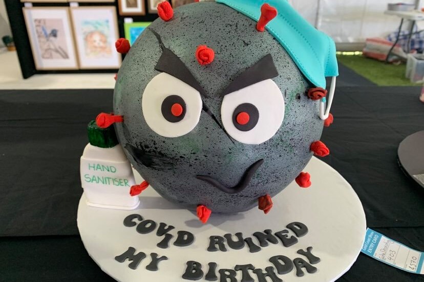 cake ball looking like a germ, with the words "COVID RUINED MY BIRTHDAY"