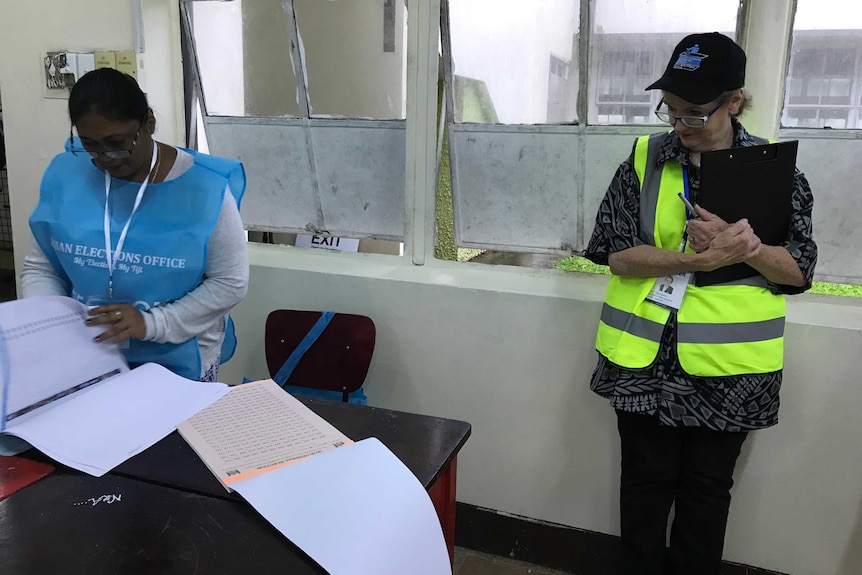 Liberal MP Jane Prentice watches an election official scroll through an election roll.