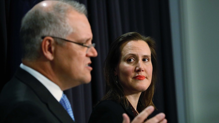 Kelly O'Dwyer looks at Scott Morrison during a press conference