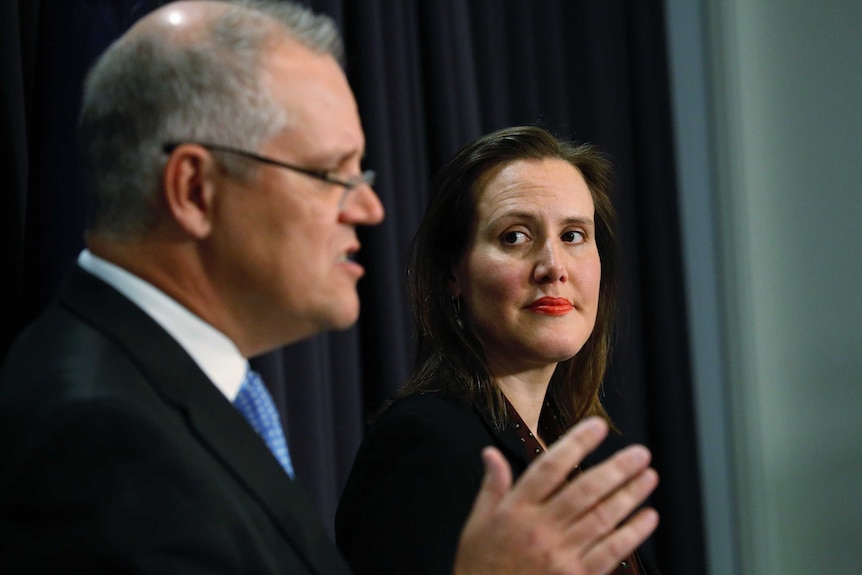 Kelly O'Dwyer looks at Scott Morrison during a press conference
