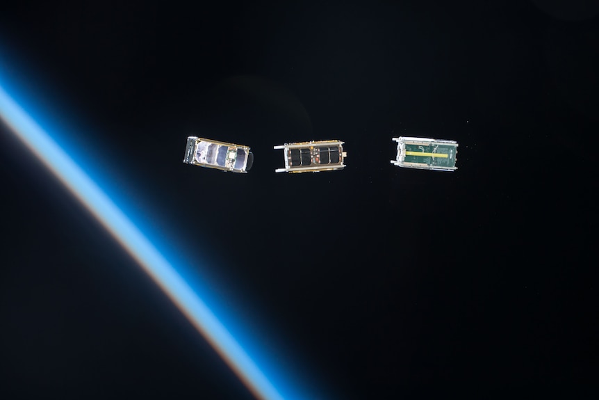 Three small cube satellites in space