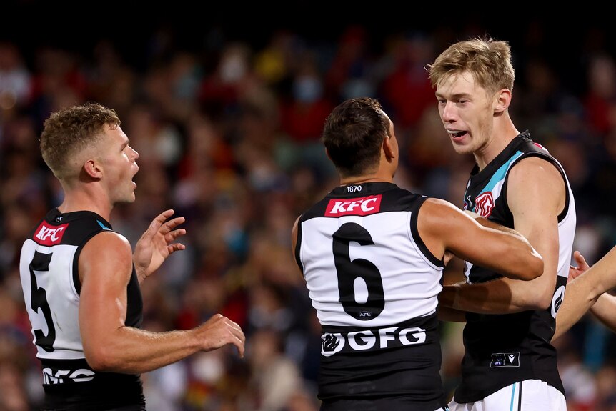 Todd Marshall celebrates a goal with his Port Adelaide Power teammates