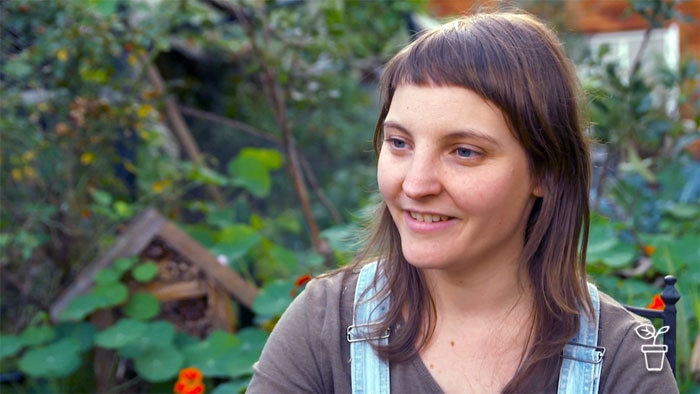 Woman standing in a garden smiling