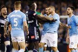 Kenny Athiu of the Victory and Luke Brattan of City tussle during the round one A-League match in Melbourne.