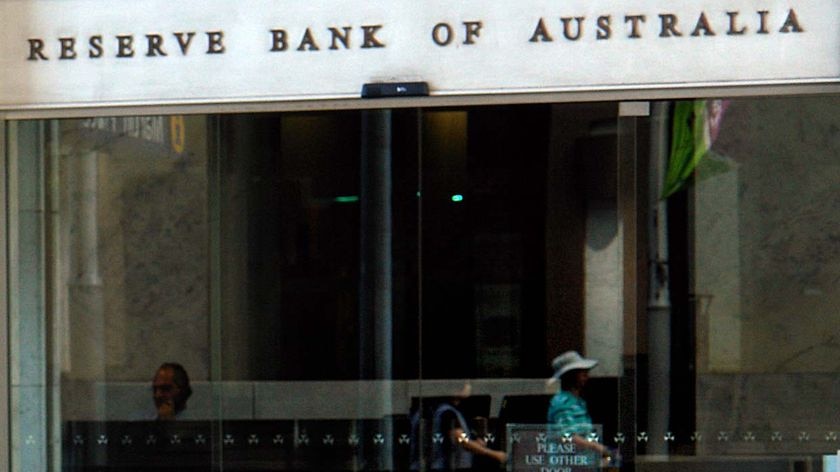 Reflection of people passing by the Reserve Bank of Australia in Sydney