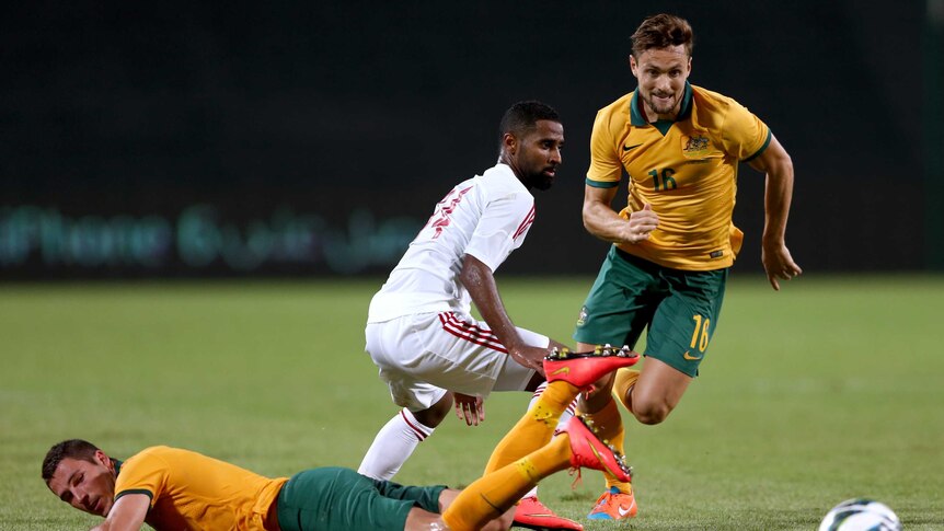 Socceroos battle for the ball against UAE