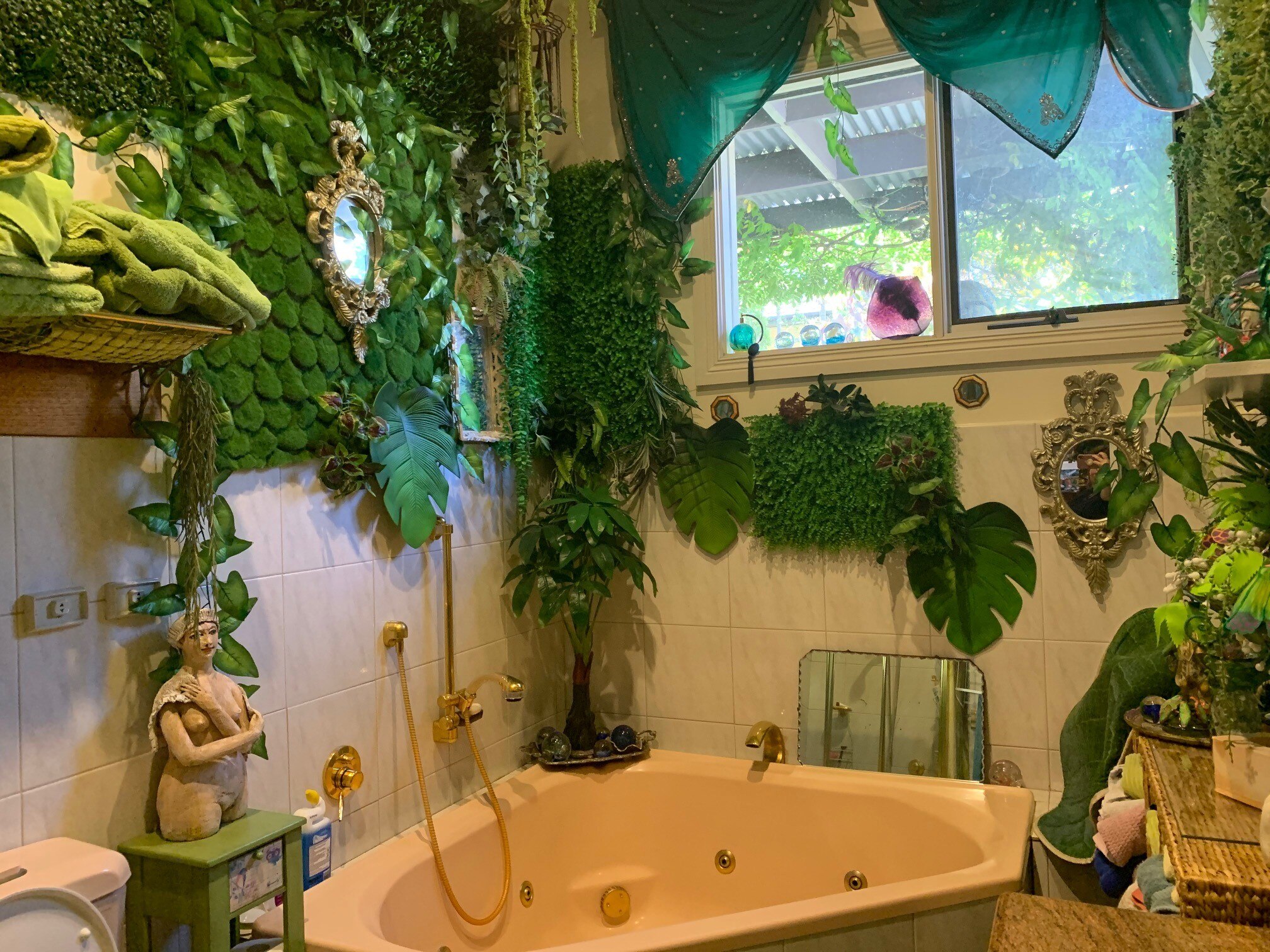bathtub surrounded in vertical garden of vines
