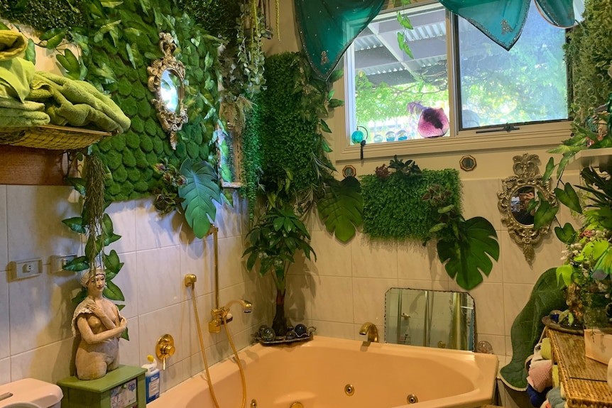 bathtub surrounded in vertical garden of vines