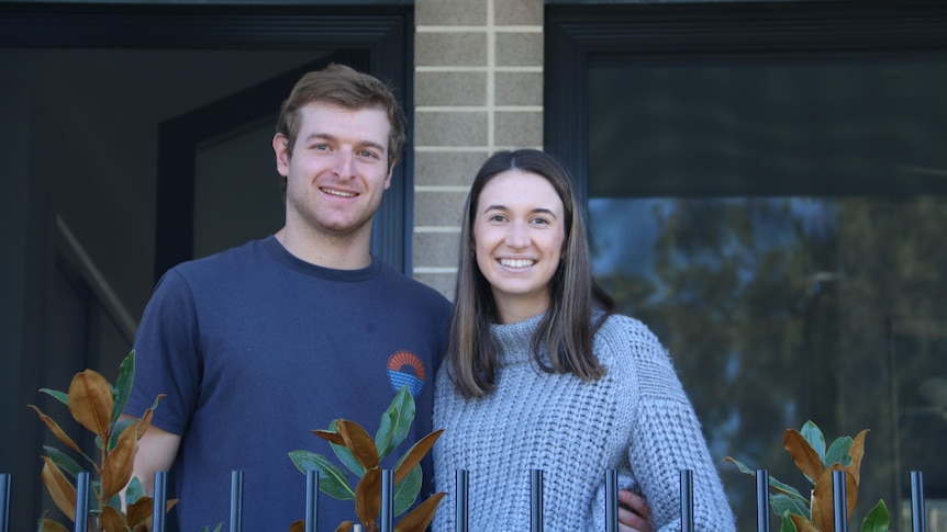 Georgia and her partner Ben outside their new terrace home at Carseldine in Brisbane's north.