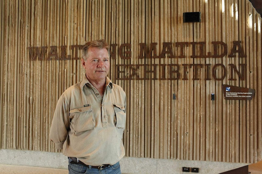 Manager Cameron Mace stands in front of Waltzing Matilda Exhibition sign inside the rebuilt centre at Winton.