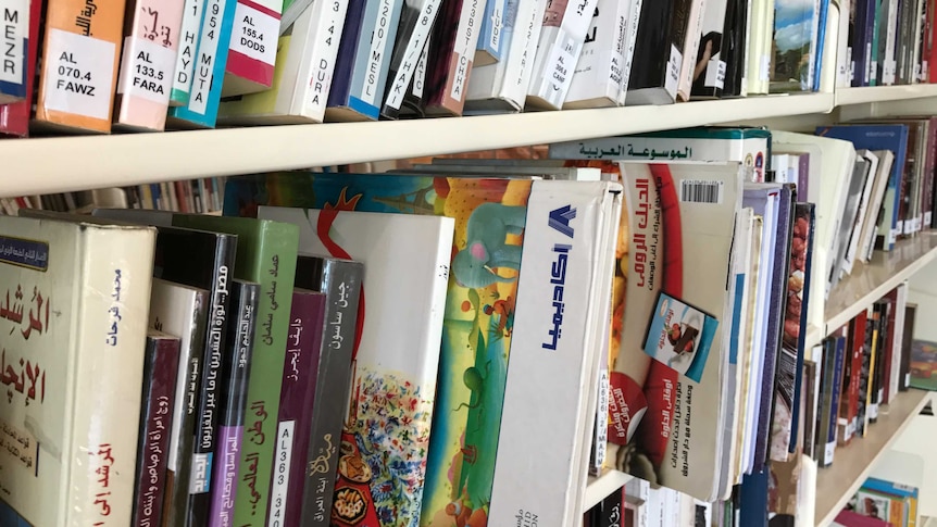 Arabic books lined up on library shelves