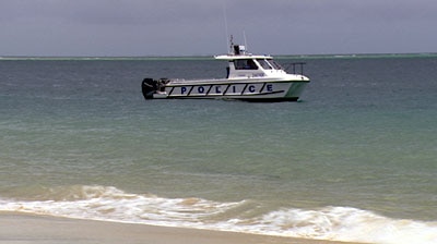 A police boat patrols at Amity Point off North Stradbroke Island.