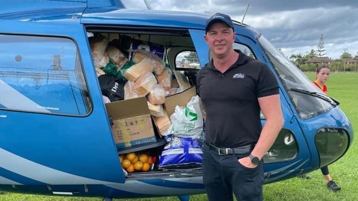 Sea World Helicopters pilot Ash Jenkinson with helicopter full of supplies behind for flood-affected communities in northern NSW